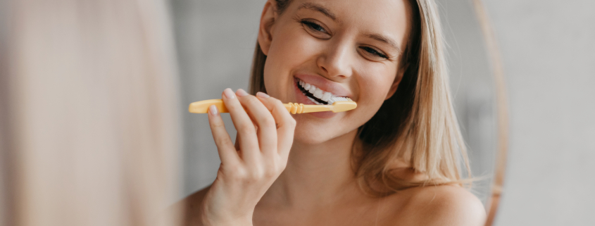 blonde woman brushing teeth