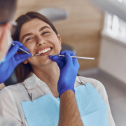 Professional,Doctor,Is,Checking,Woman’s,Teeth,In,Light,Modern,Dental woman getting teeth checked at dentist