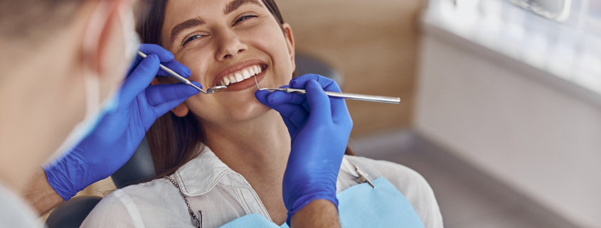 woman getting teeth checked at dentist