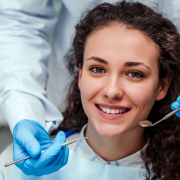 Health,Check.,Dentist,In,Stomatology,Center,Is,Making,An,Examination young brunette female at the dentist for a general checkup