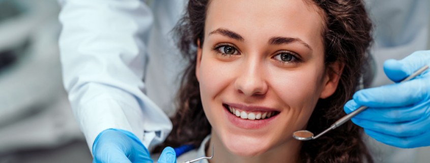 young brunette female at the dentist for a general checkup