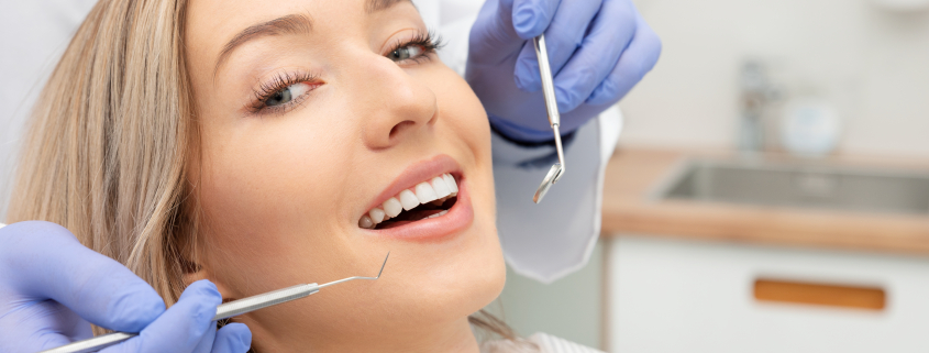 caucasian woman getting teeth checked at the dentist