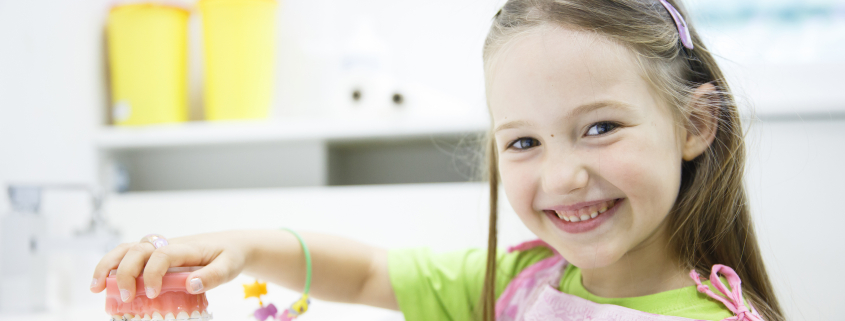 little girl looking at braces for her teeth