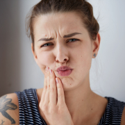 woman in pain from grinding teeth