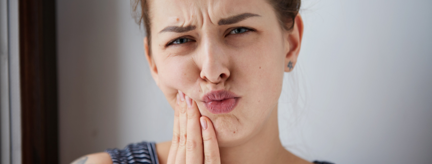 woman in pain from grinding teeth